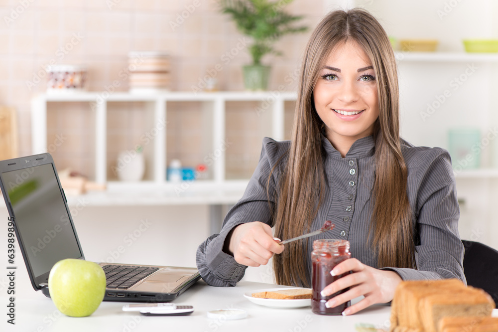 Businesswoman in the kitchen preparing breakfast. Businesswoman in the kitchen preparing breakfast.