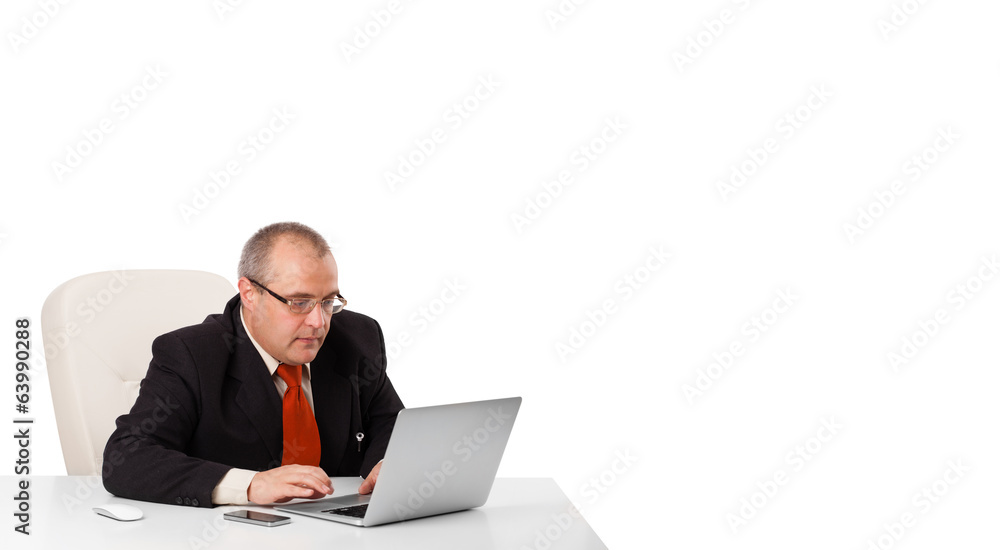 buisnessman sitting at desk and looking laptop with copy space buisnessman sitting at desk and looking laptop with copy space