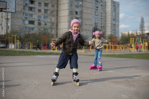 Young girl riding on roller skates.