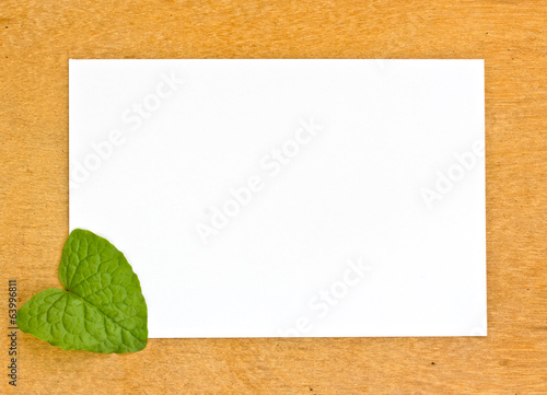 Slika na platnu blank pape and leaf on wooden bords