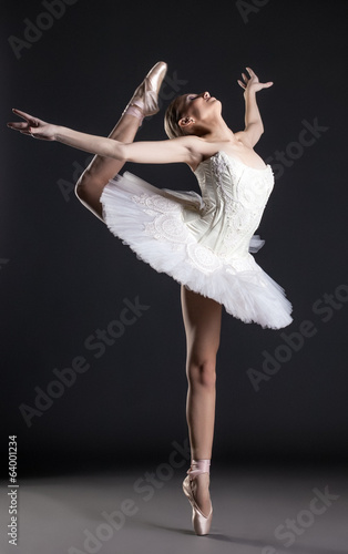 Fototapeta Image of flexible cute ballerina dancing in studio