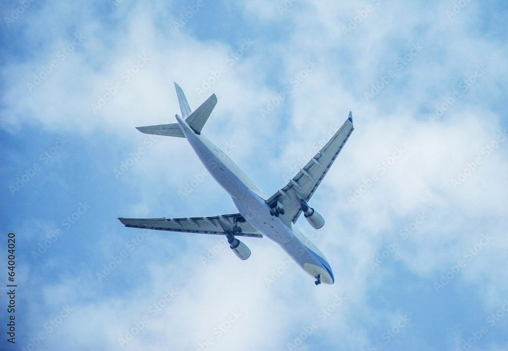 Fototapeta premium Airplane among the clouds
