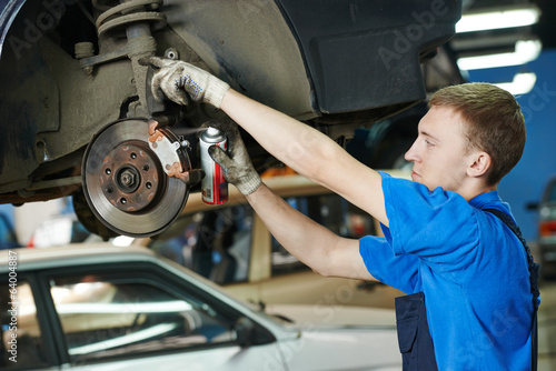 auto mechanic at car brake shoes replacement