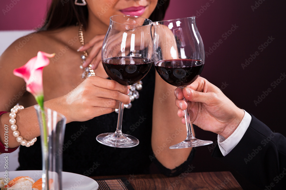 Couple Toasting Wineglasses In Restaurant Couple Toasting Wineglasses In Restaurant