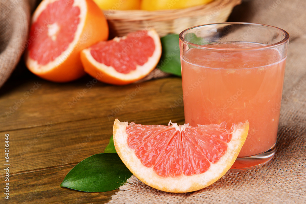 Ripe grapefruit with juice on table close-up Ripe grapefruit with juice on table close-up