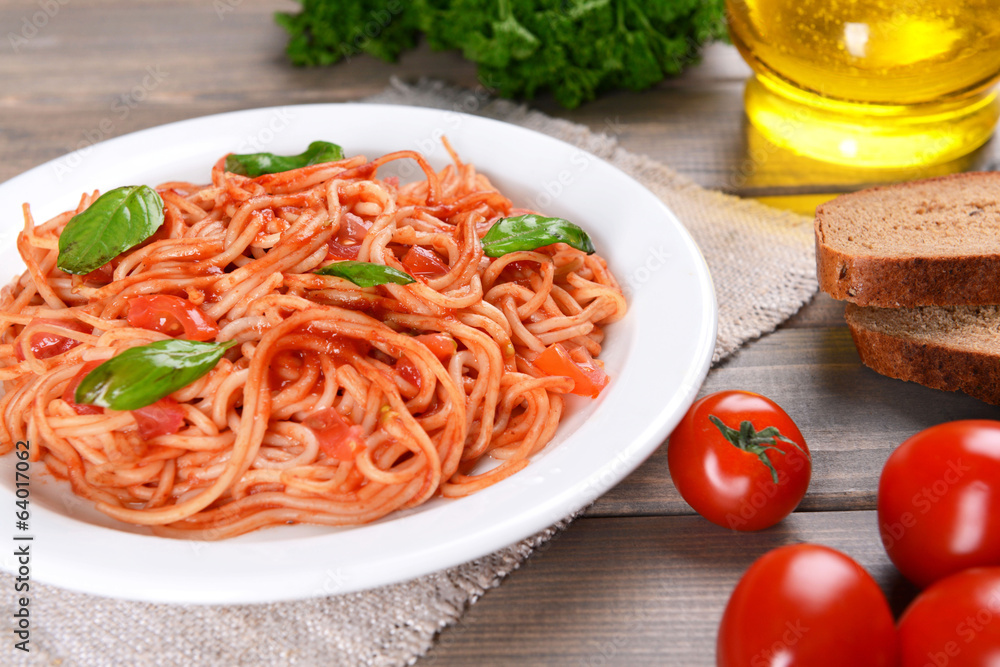 Pasta with tomato sauce on plate on table close-up Pasta with tomato sauce on plate on table close-up