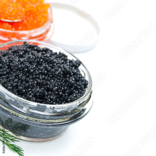 close-up of black caviar in a glass jar, isolated