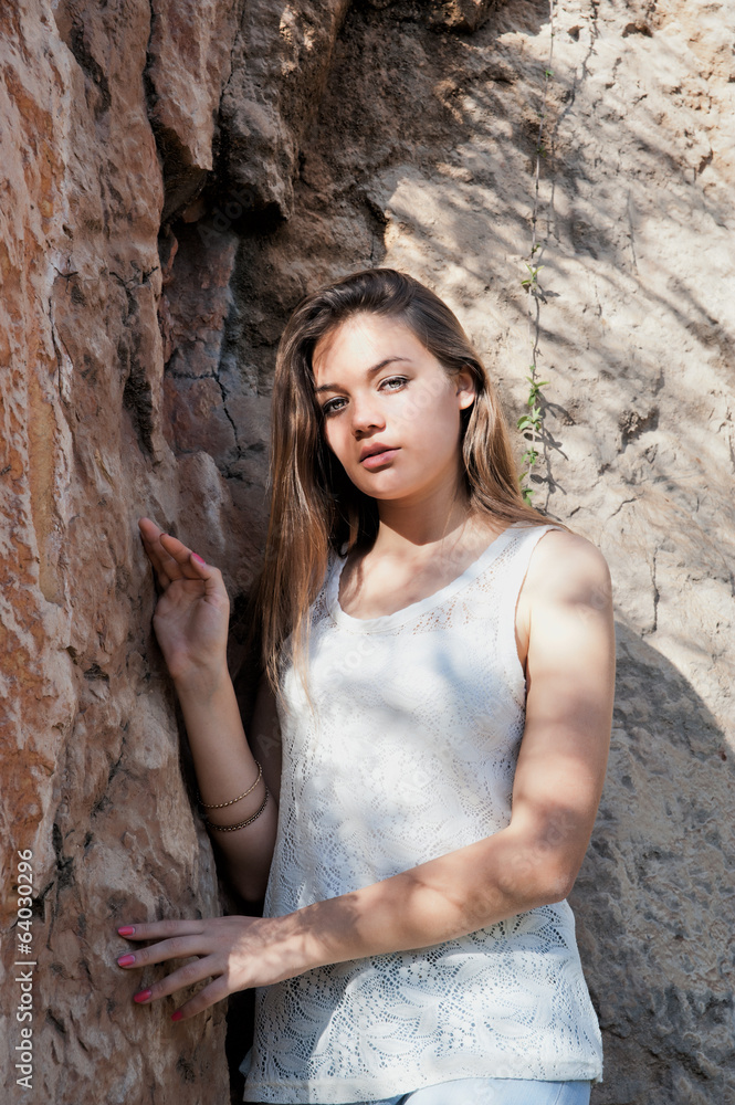 Portrait of a girl against against the rock Portrait of a girl against against the rock