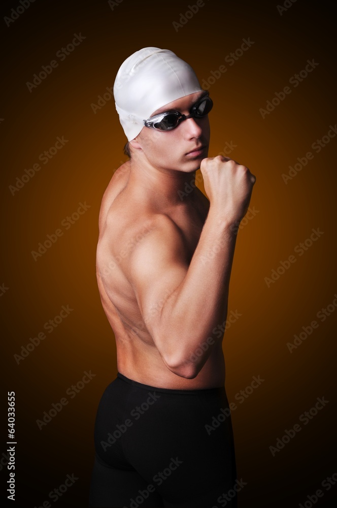 Male swimmer isolated on black