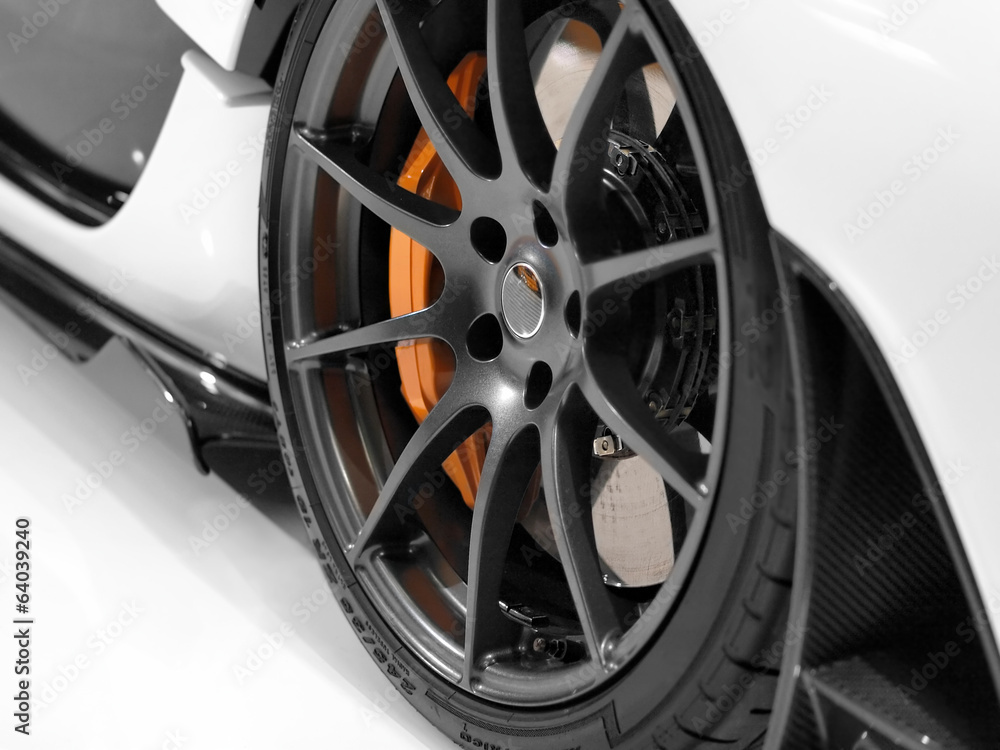Close up of a sports car´s alloy wheel. Close up of a sports car´s alloy wheel.