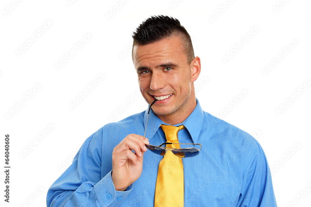 Smiling businessman in blue shirt poses with sunglasses Smiling businessman in blue shirt poses with sunglasses