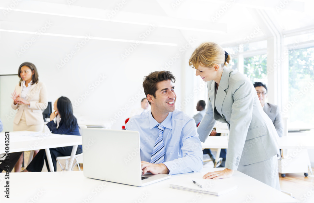Boss Guiding her Employee in Front of the Laptop