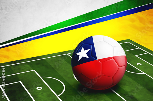 Soccer ball with Chile flag on pitch