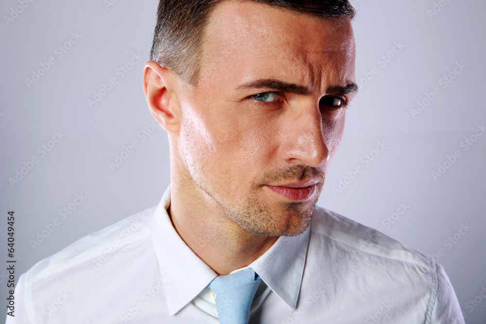 Portrait of a handsome businessman on gray background Portrait of a handsome businessman on gray background