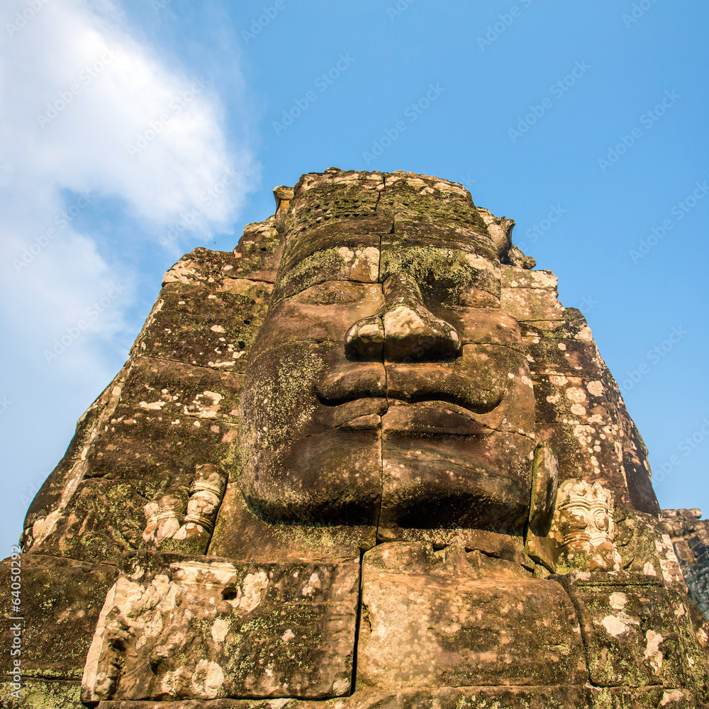 Stone faces on the towers of ancient Bayon Temple in Angkor Thom Stone faces on the towers of ancient Bayon Temple in Angkor Thom