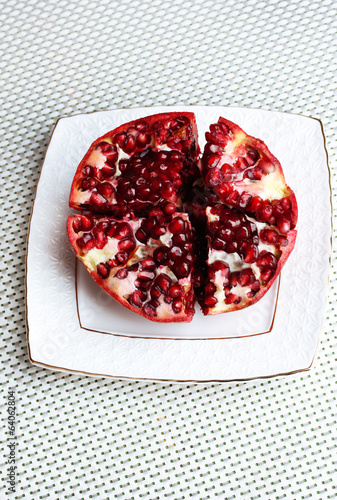 Wallpaper Mural Ripe pomegranate on plate,  on light background Torontodigital.ca