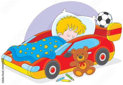 Little boy sleeps in his bed made as a sport car #64065030