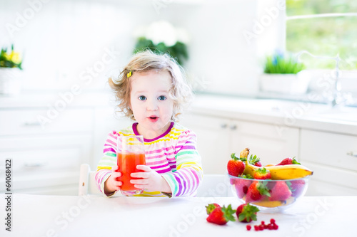 Girl wearing colorful shirt having breakfast next window shirt