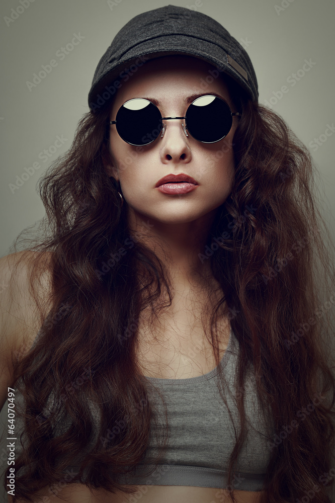 Closeup fashion woman portrait in glasses and cap. Vintage style Closeup fashion woman portrait in glasses and cap. Vintage style