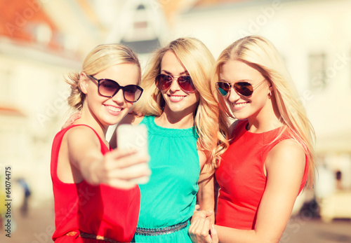 beautiful girls taking picture in the city