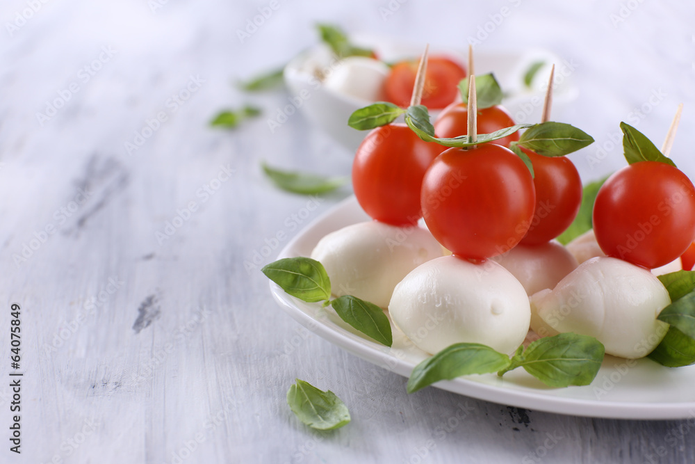 Tasty mozzarella cheese with basil and tomatoes Tasty mozzarella cheese with basil and tomatoes