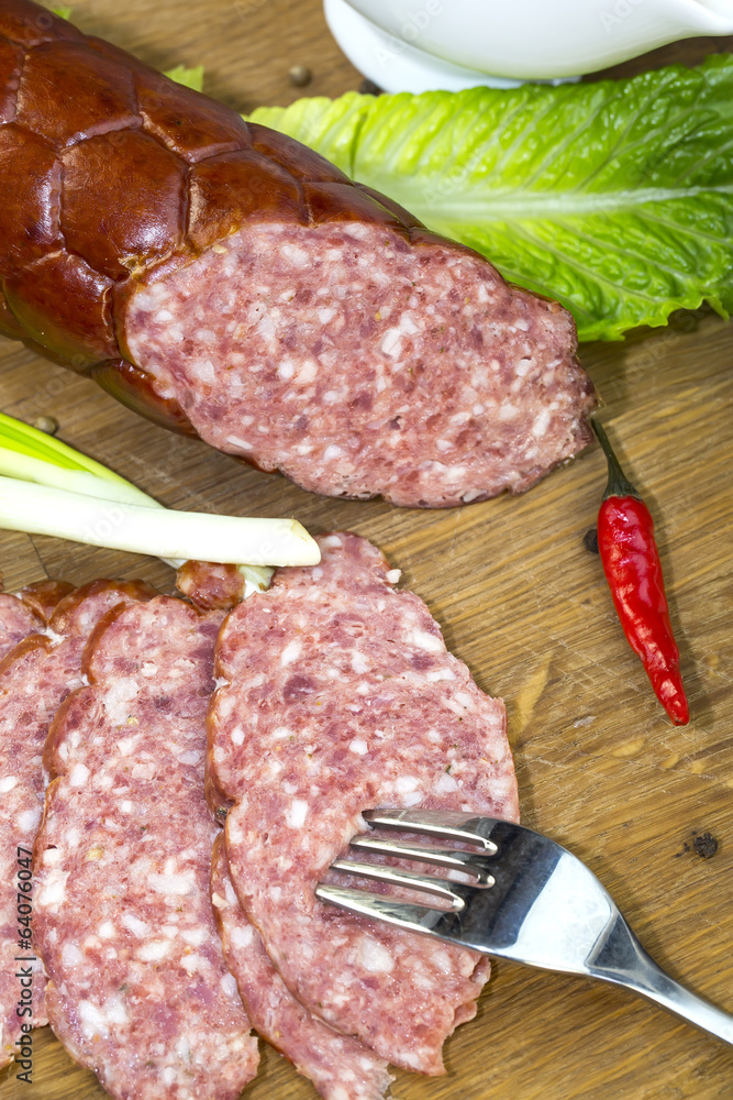 sausage on a wooden plate in a restaurant sausage on a wooden plate in a restaurant