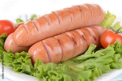 Grilled sausage on plate on table close-up