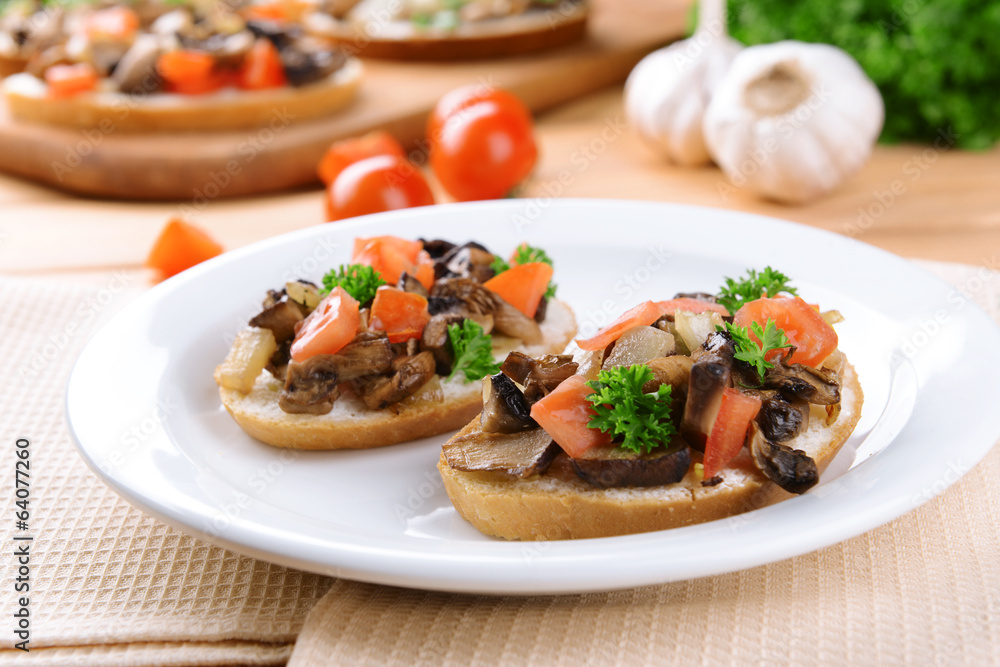 Delicious bruschetta with mushrooms on plate on table close-up Delicious bruschetta with mushrooms on plate on table close-up