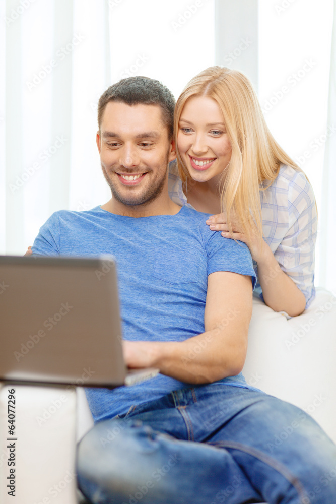 smiling happy couple with laptop at home smiling happy couple with laptop at home
