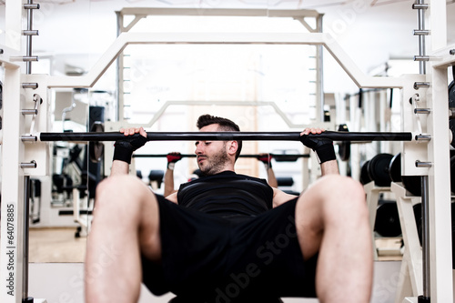 bodybuilder training in the gym: chest - barbell incline bench