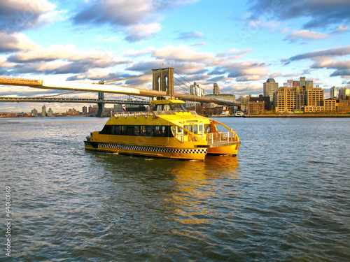 Water Taxi and Brooklyn bridge, seen from Pier 17, at Lower Manh photo