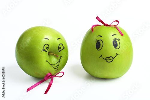 apples with comically painted faces on a white background