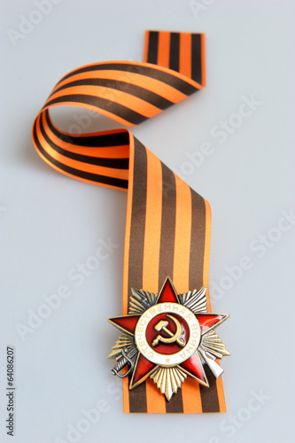 Saint George ribbon with order of Great Patriotic war on gray photo