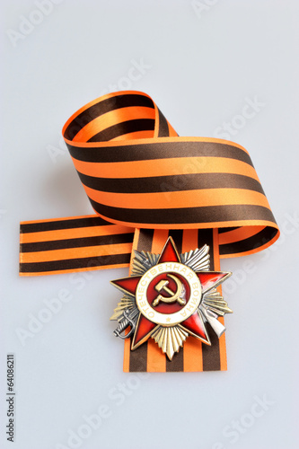 Saint George ribbon with order of Great Patriotic war on gray photo