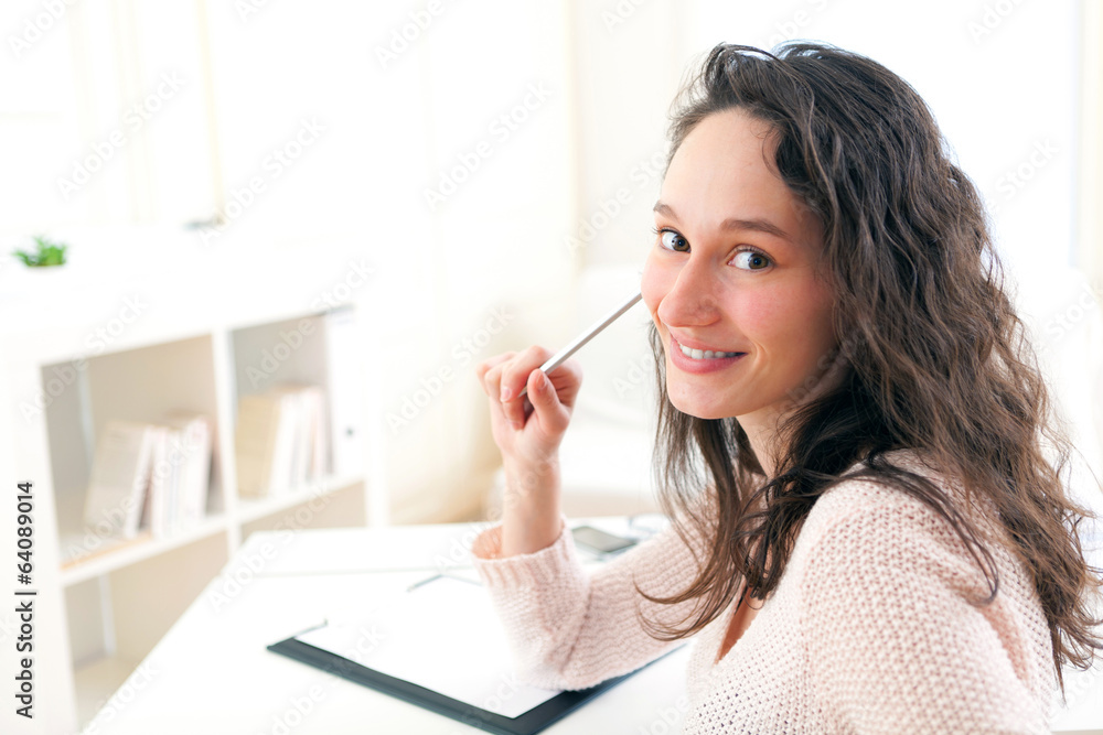 Young attractive business woman copying data on paper Young attractive business woman copying data on paper