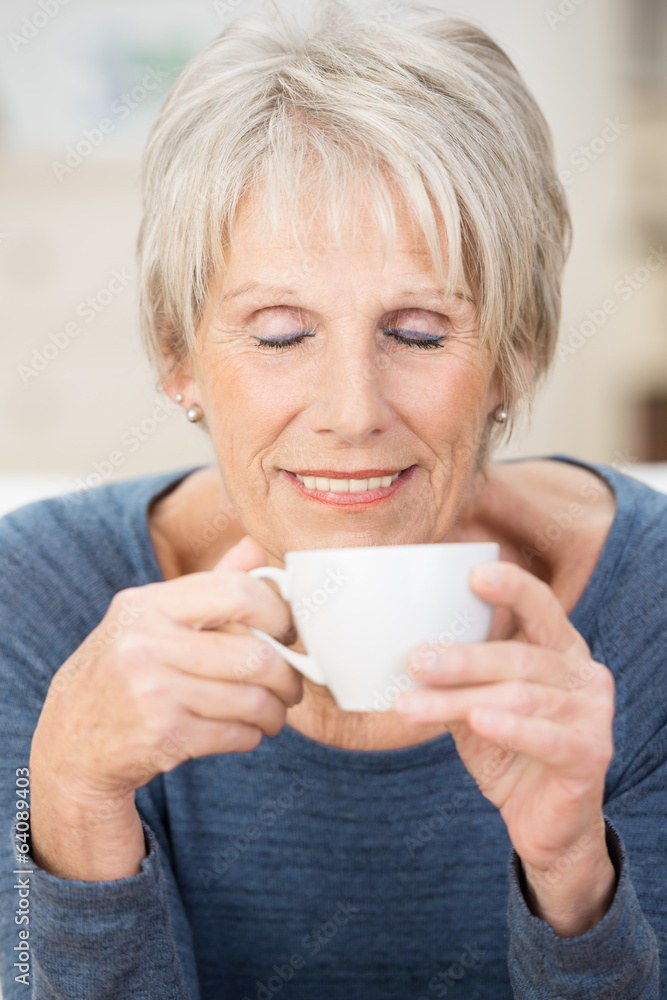 entspannte ältere frau genießt eine tasse kaffee entspannte ältere frau genießt eine tasse kaffee