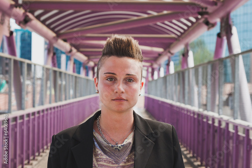Pretty short hair girl posing on a bridge