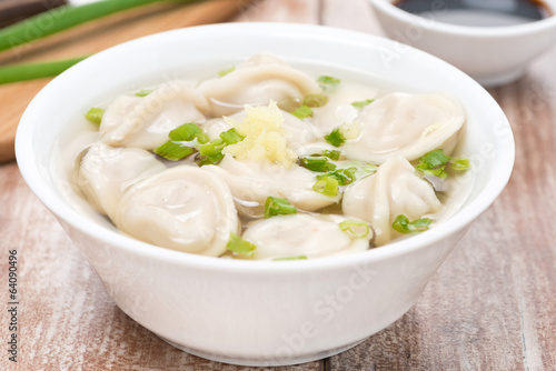 Chinese dumplings in chicken broth, close-up