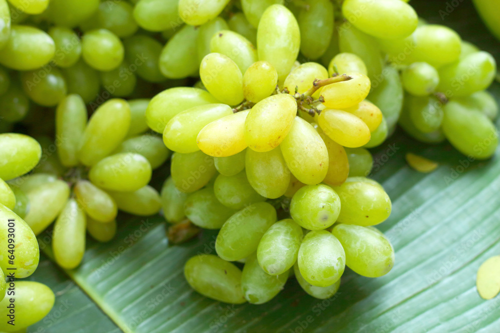Fresh grapes on green banana leaves