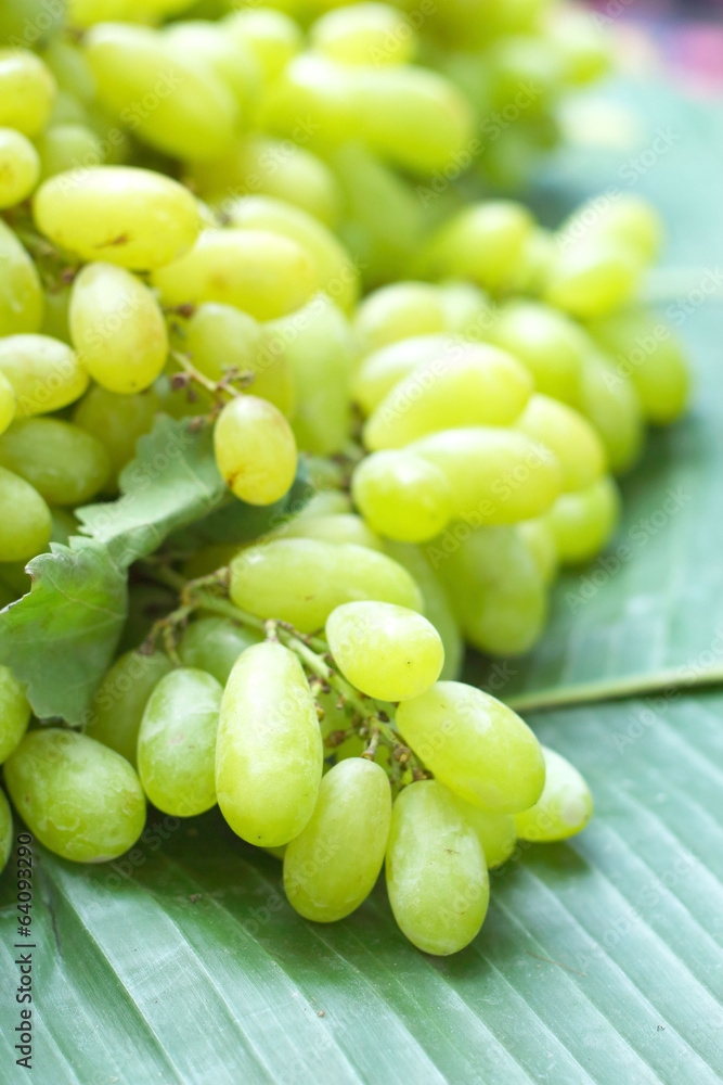 Fresh grapes on green banana leaves Fresh grapes on green banana leaves