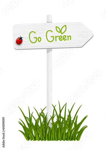 Wooden signpost with green grass