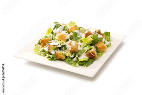 Tapety artystyczne Caesar salad in a white plate