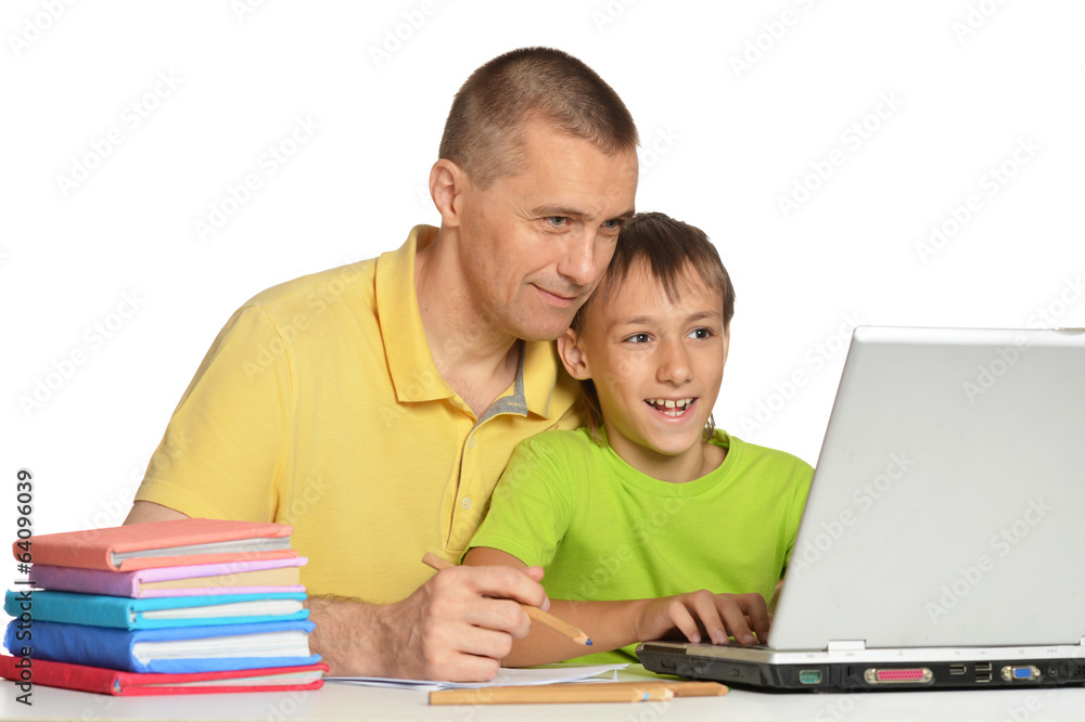 Boy doing homework with father Boy doing homework with father