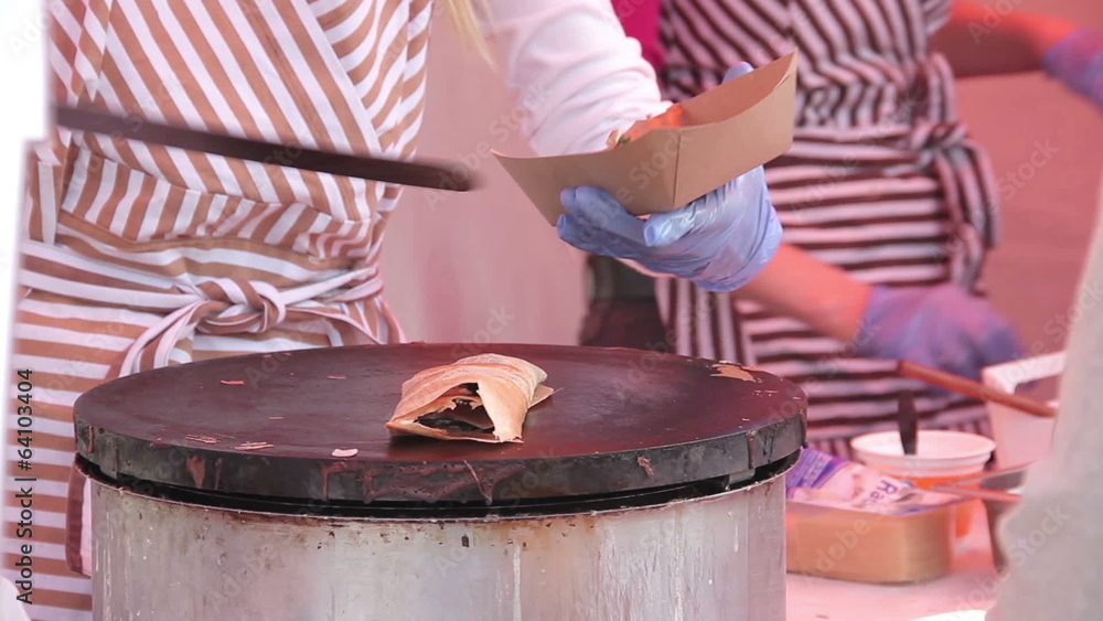 Middle aged caucasian woman making pancakes at local farmers mar