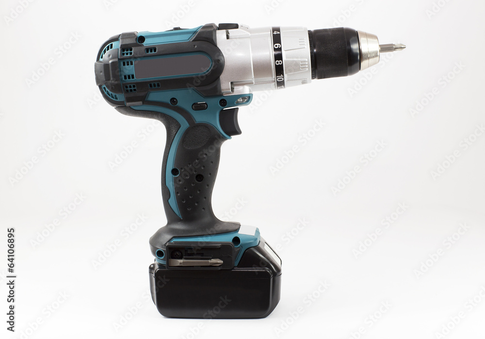 Compact high power cordless drill on the light background Compact high power cordless drill on the light background