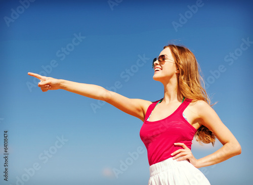 girl showing direction on the beach