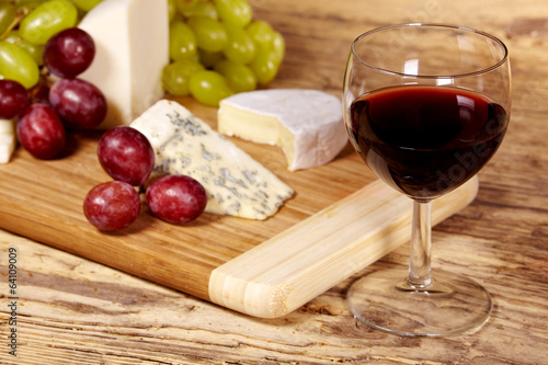 A red glass of wine and cheese