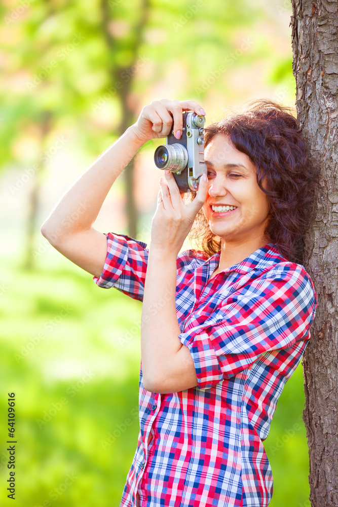 Indian girl with camera in the park.