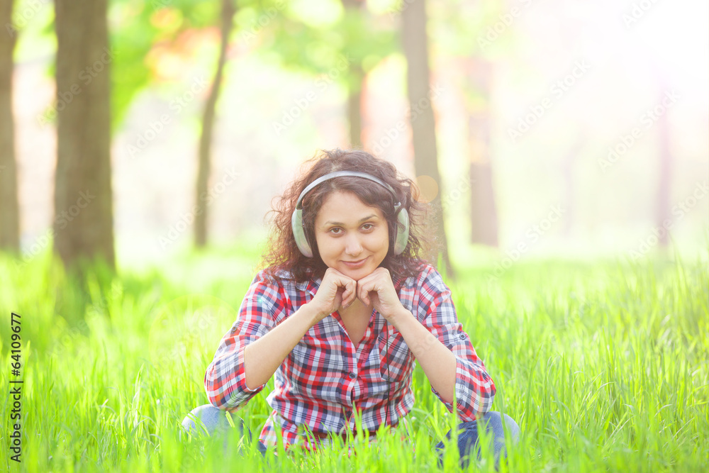 Indian girl with headphones in the park. Indian girl with headphones in the park.