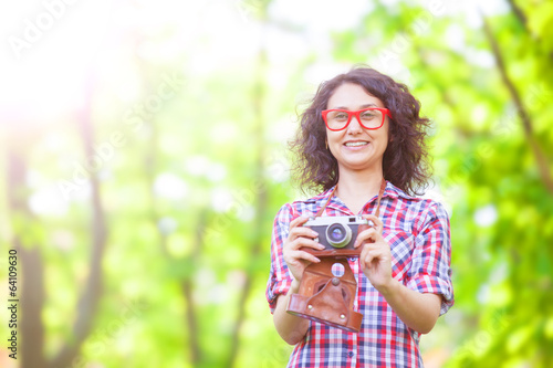 Canvas Print Indian girl with camera in the park.